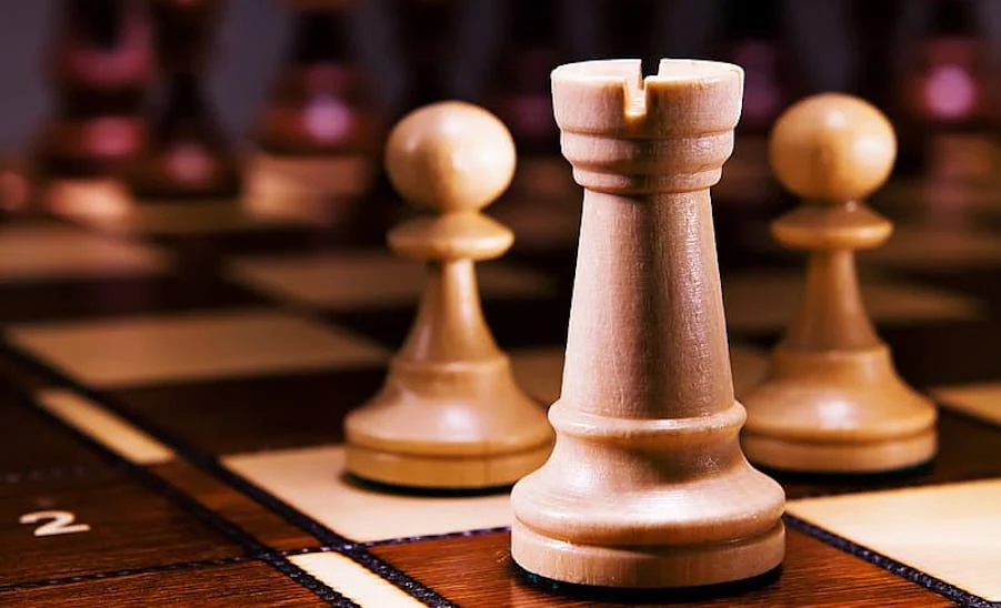 white-chess-piece-on-brown-wooden-table